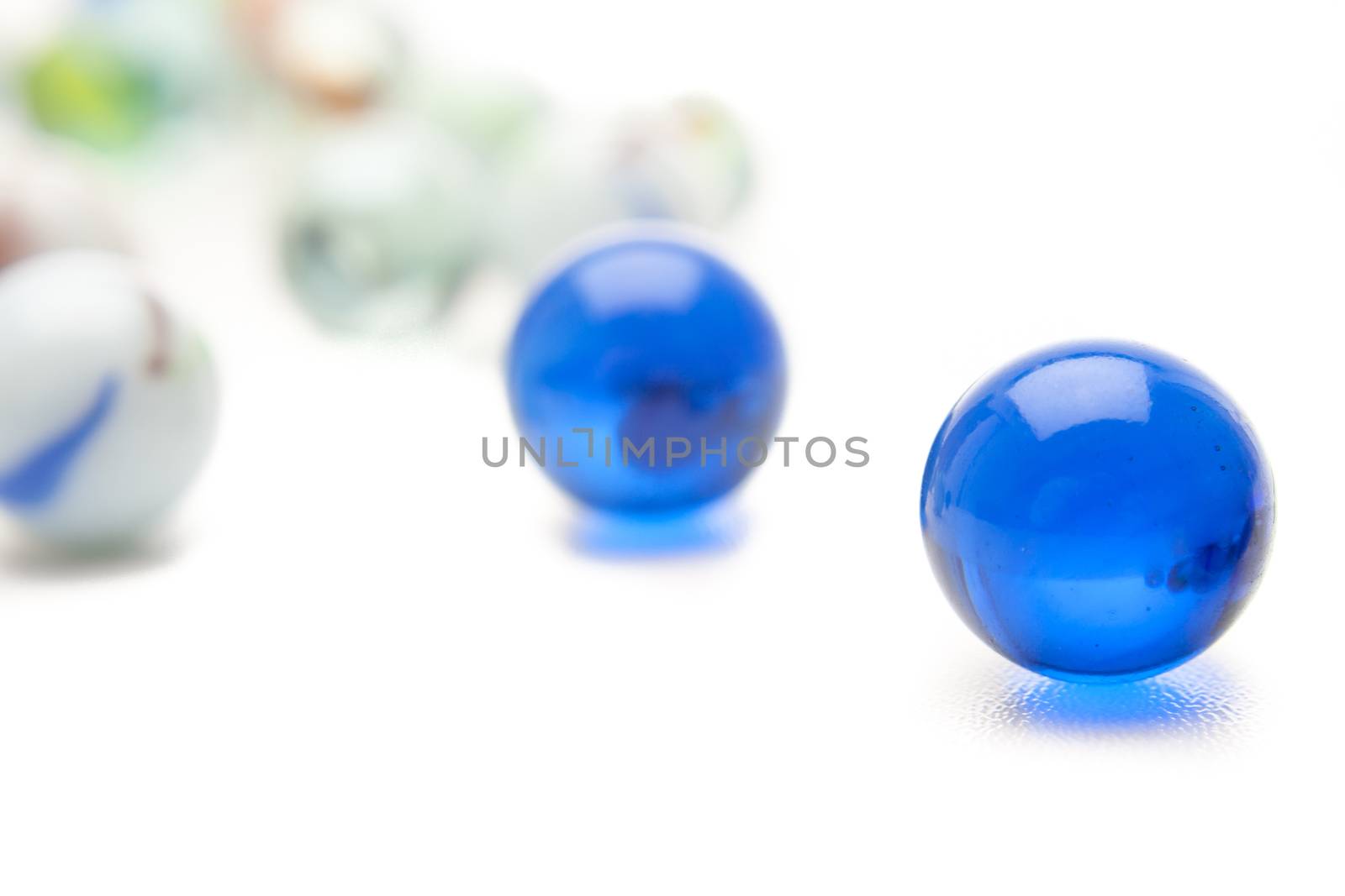 photo of different color marbles on white