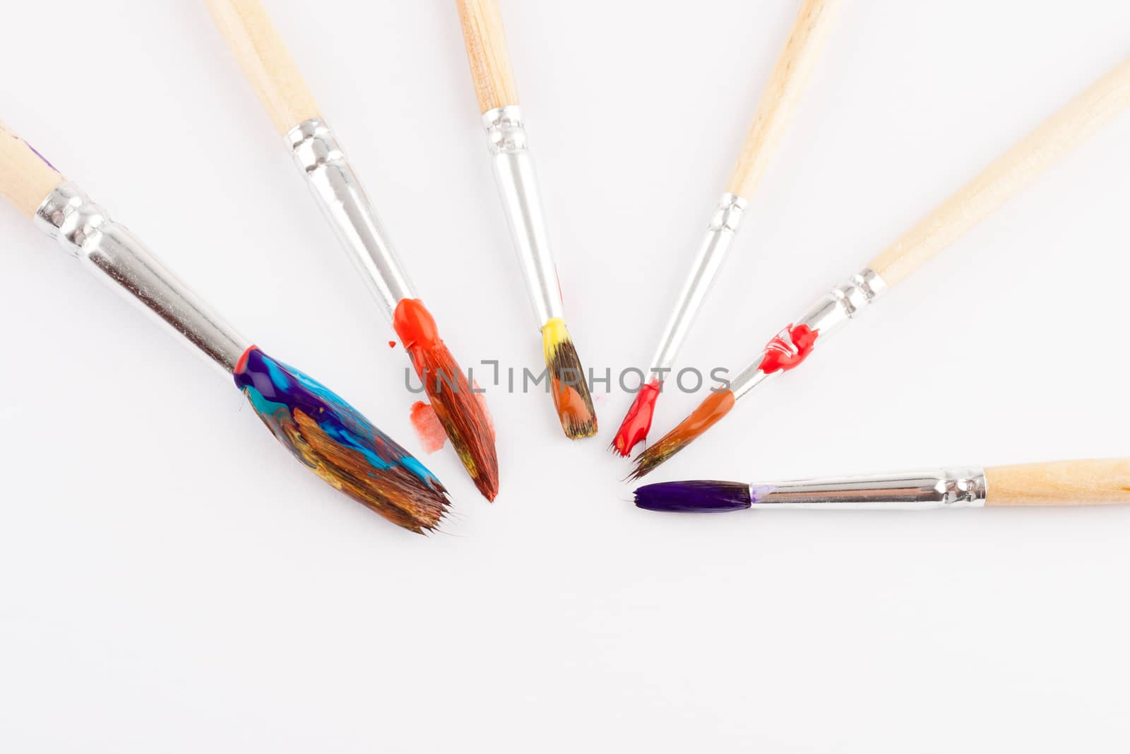 different size artist paint brushes on white