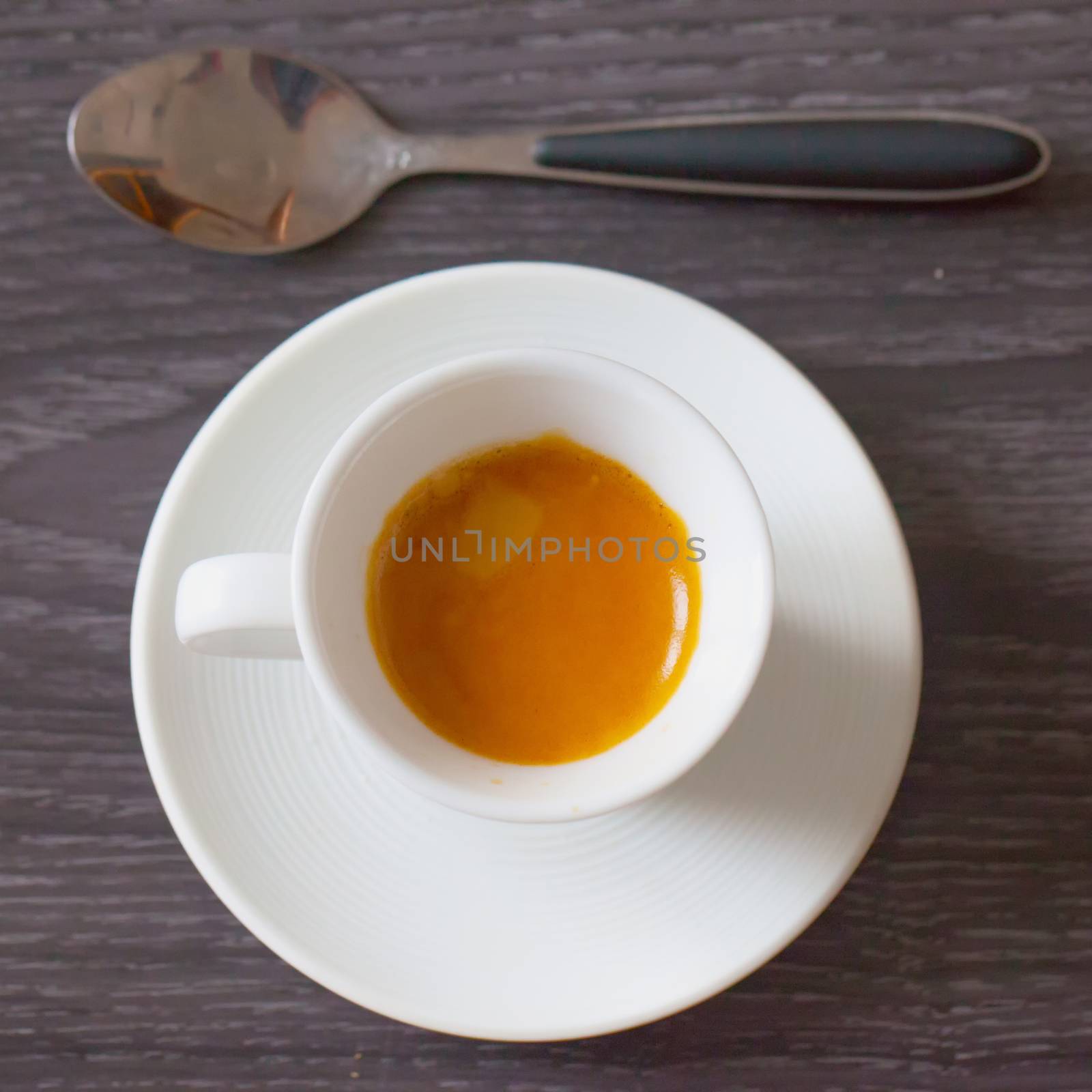 Coffee cup from above, over dark wooden table