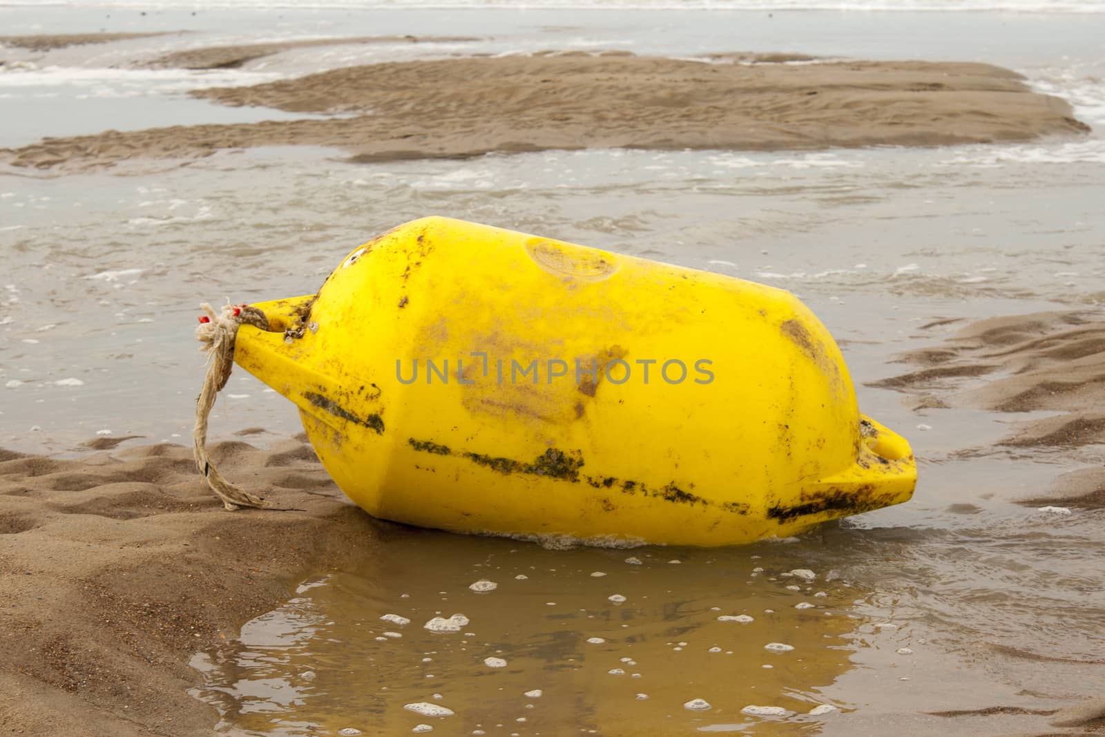 Yellow sea buoy at the beach offshore