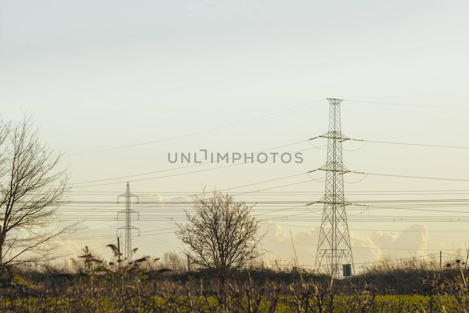 high voltage pylon with cables and landscape