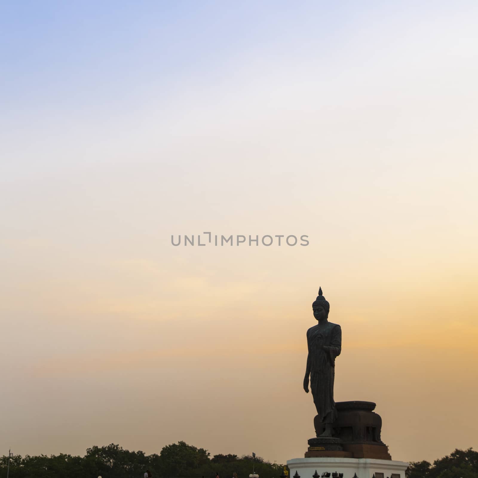Big Buddha in the evening. The dark sky with bright sunshine in the evening.