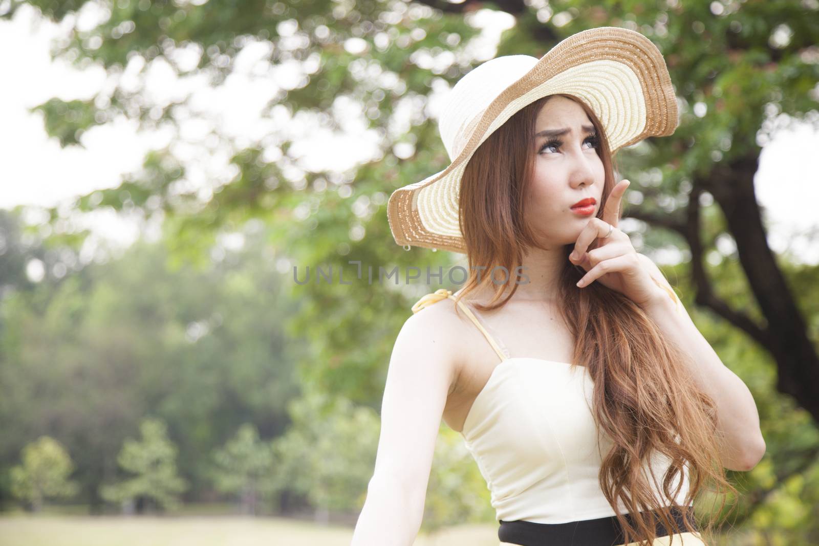 Woman relaxing in the park during the holidays. Park area with trees and nature.