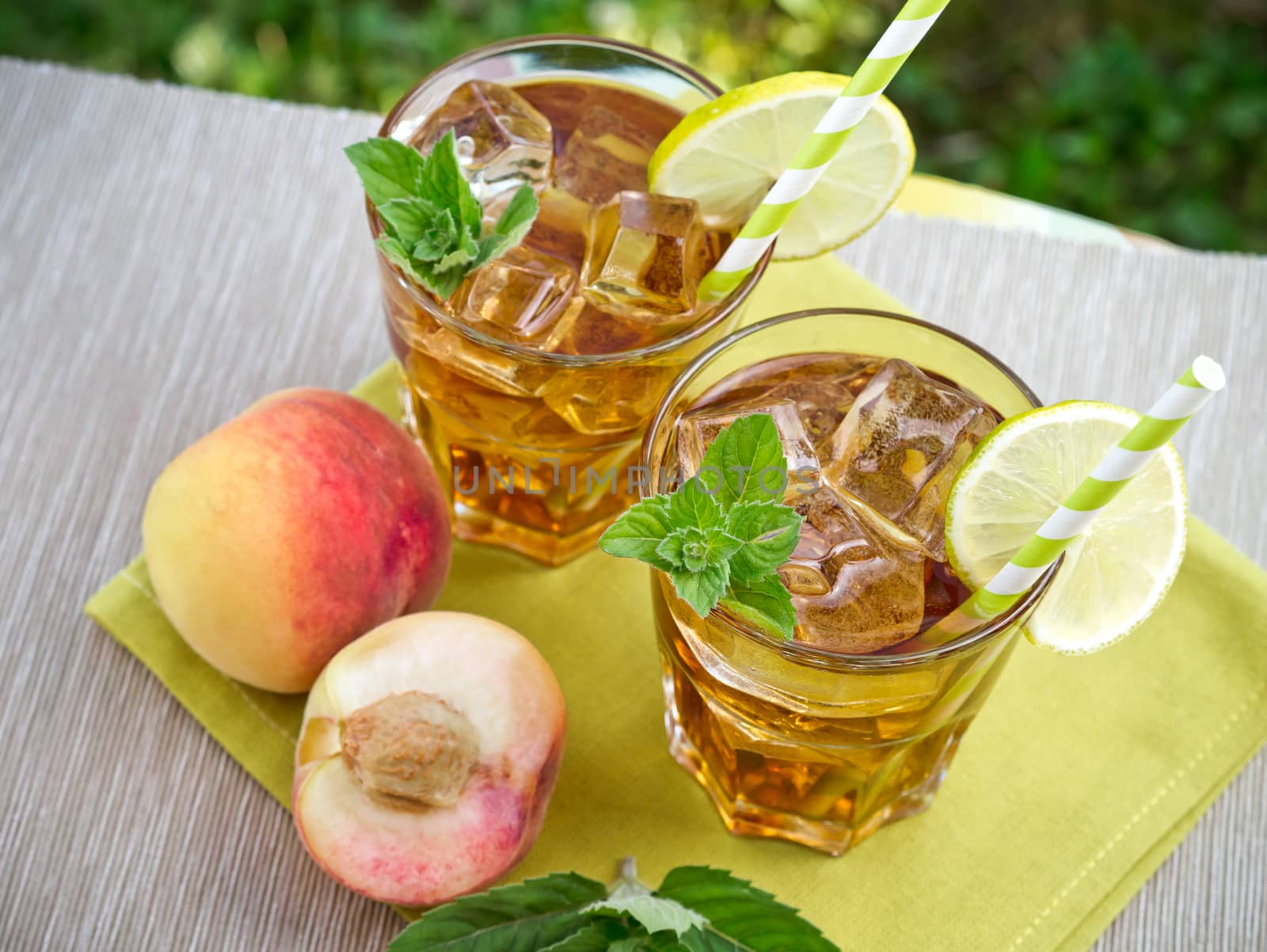 Refreshing peach, lime and mint ice tea served outdoors