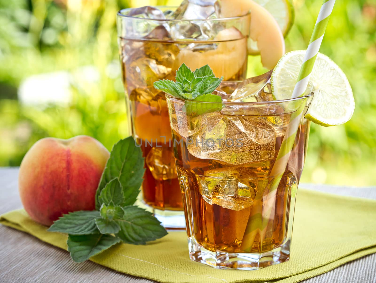 Refreshing peach, lime and mint ice tea served outdoors