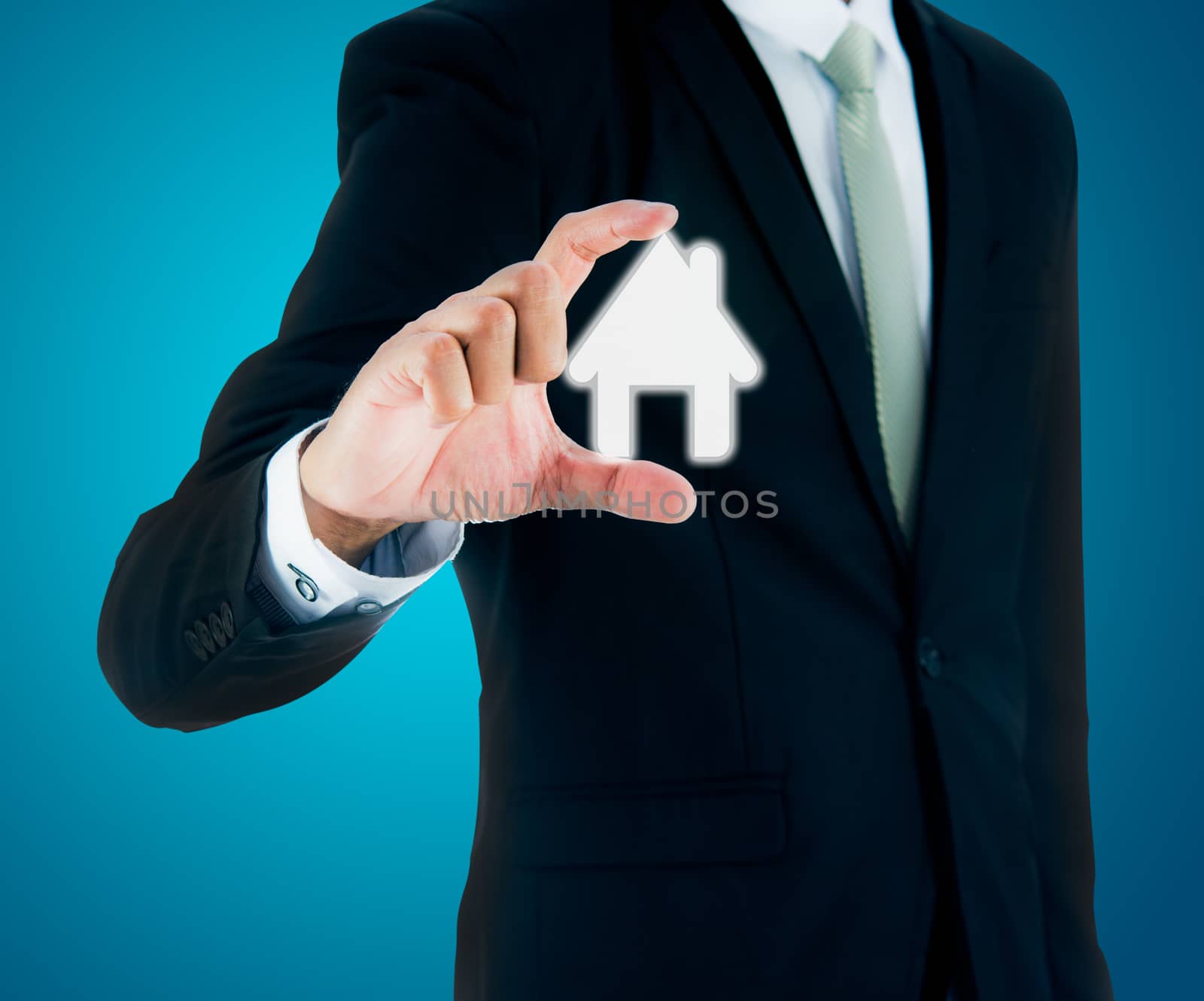 Businessman standing posture hand holding house icon isolated by Sorapop