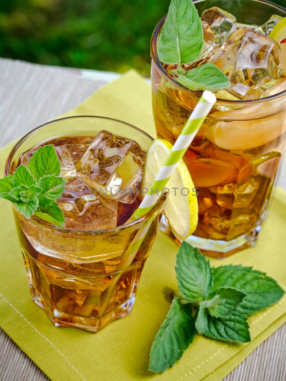 Refreshing peach, lime and mint ice tea served outdoors