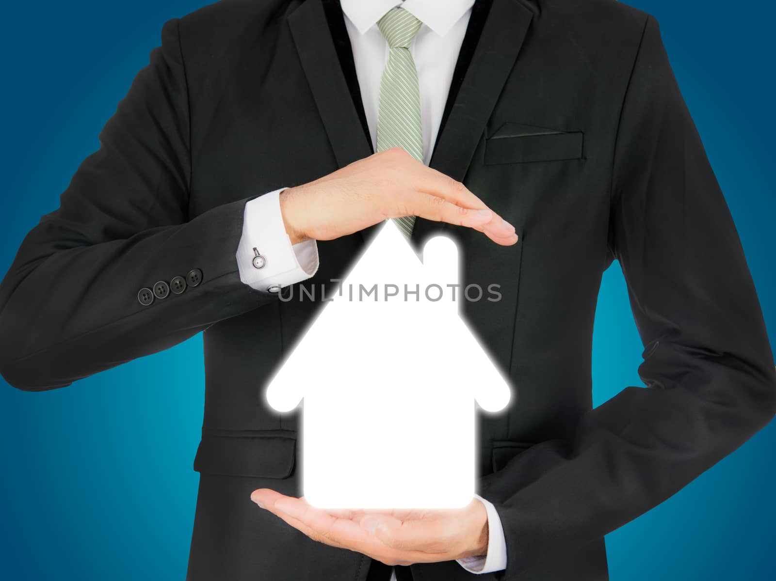 Businessman standing posture hand holding house icon isolated by Sorapop