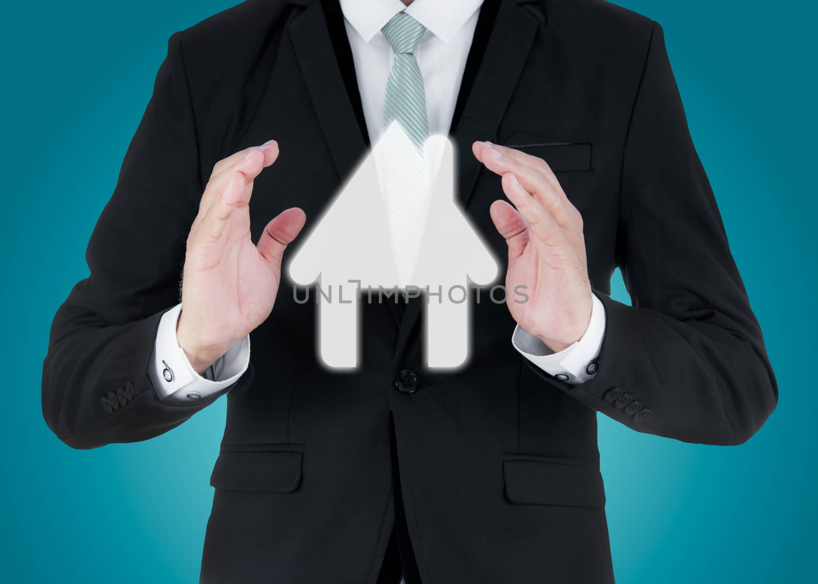 Businessman standing posture hand holding house icon isolated on over blue background