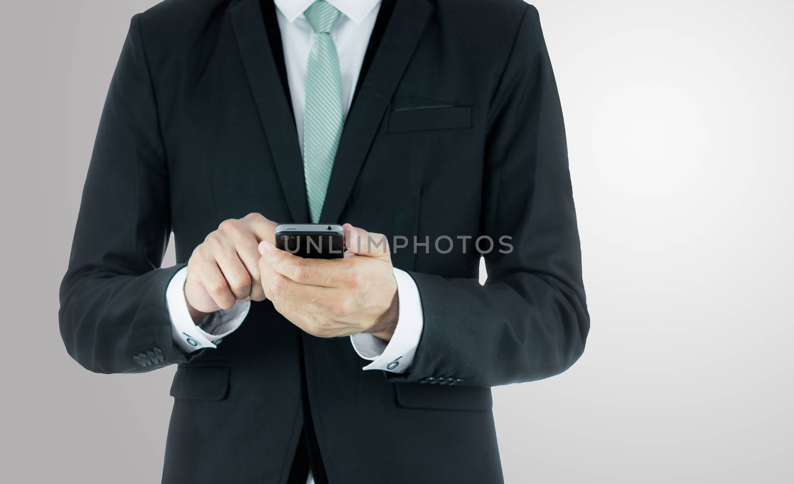 Businessman standing posture hand hold phone isolated on over gray background