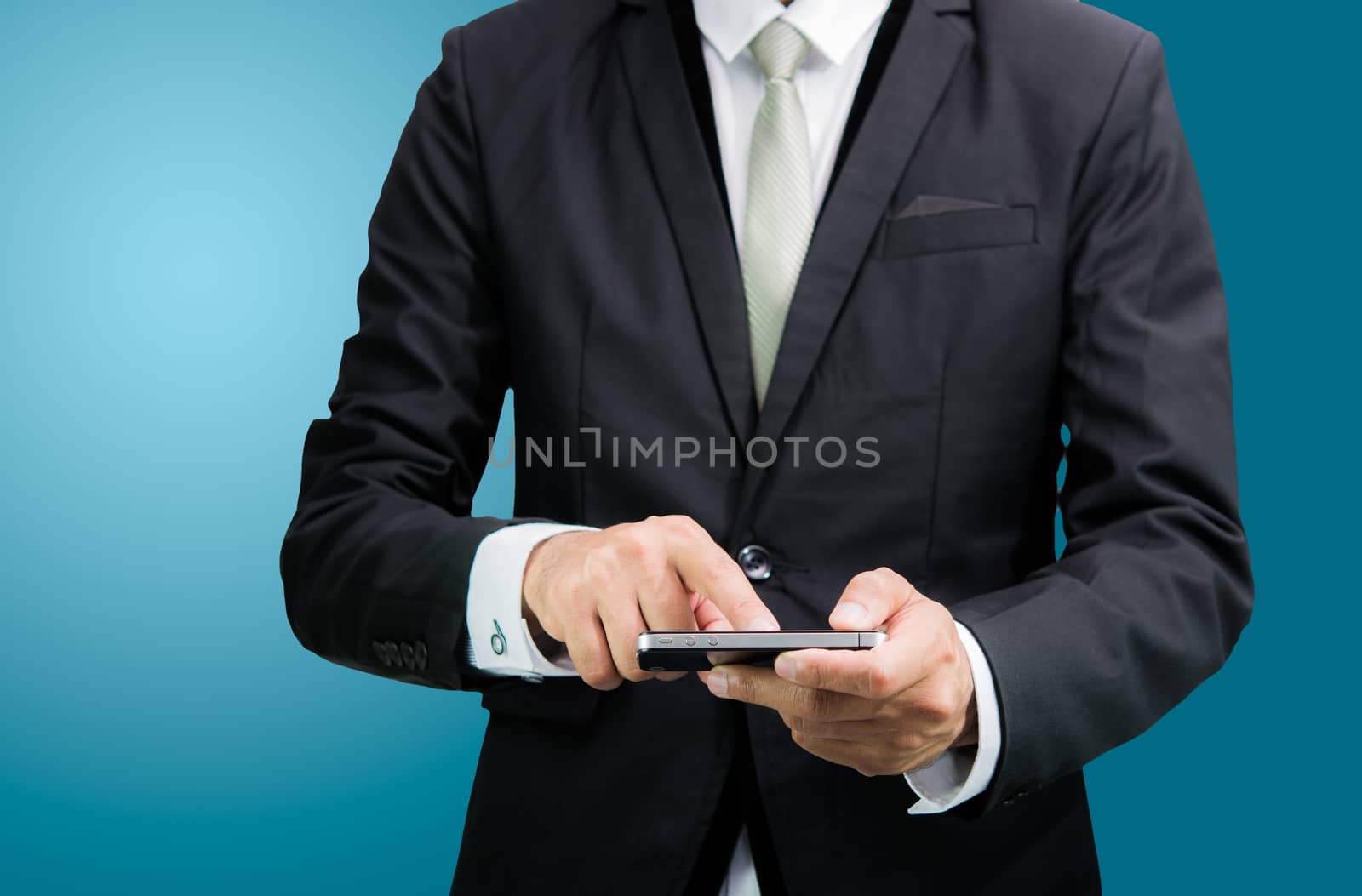 Businessman standing posture hand hold phone isolated on over blue background