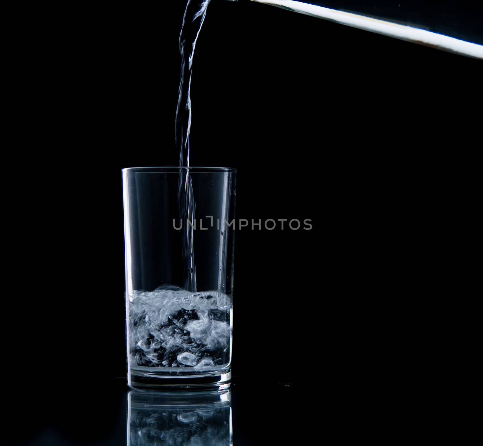 Pouring water on glass by Sorapop