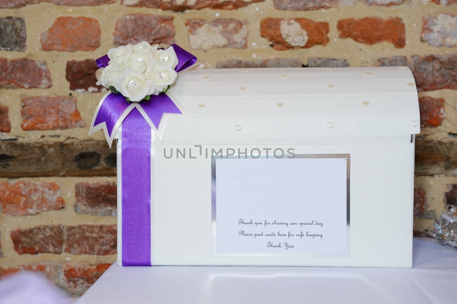Wedding reception cardbox closeup showing purple ribbon detail