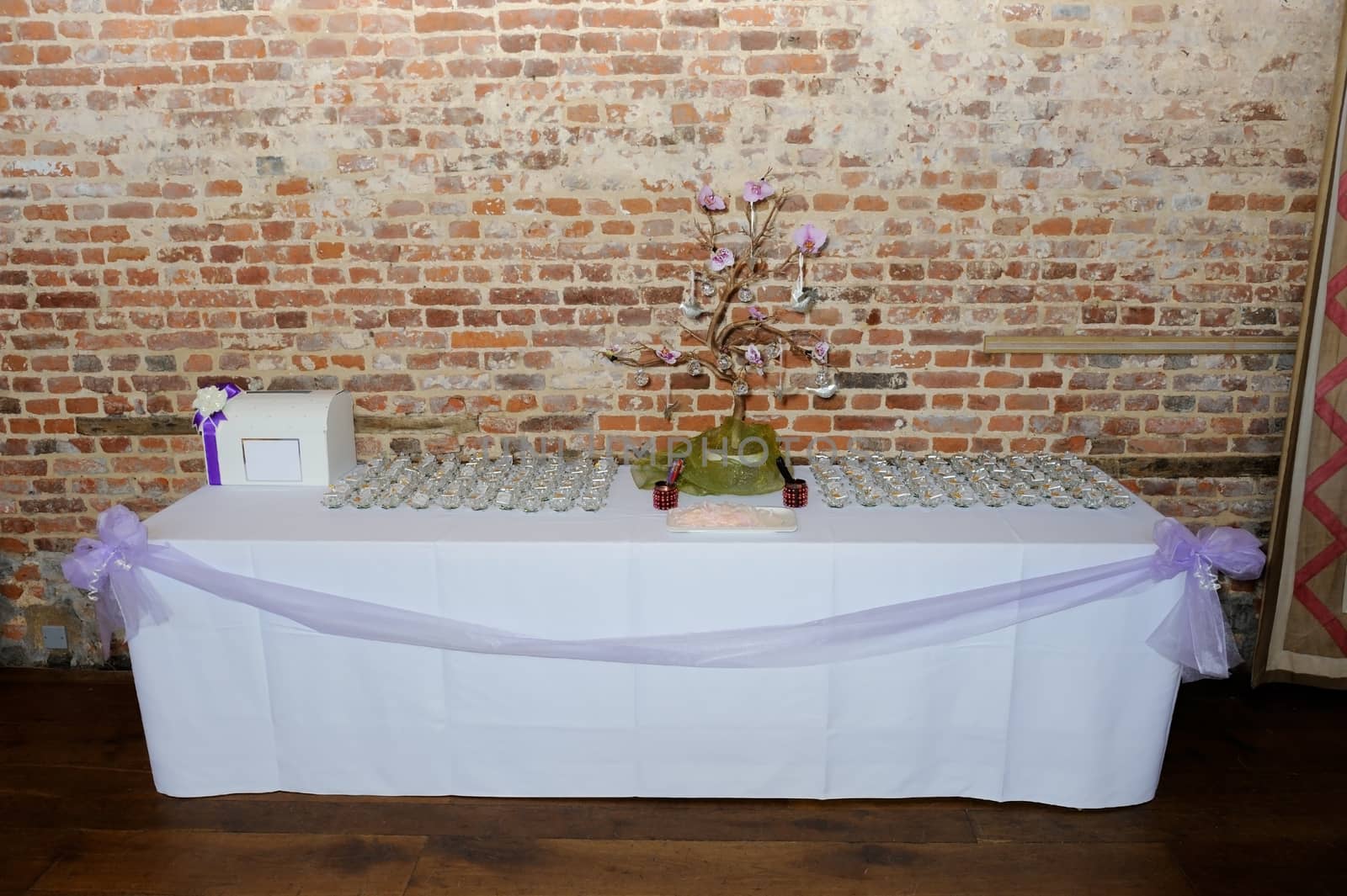 Wedding reception unusual table decorations with purple ribbon