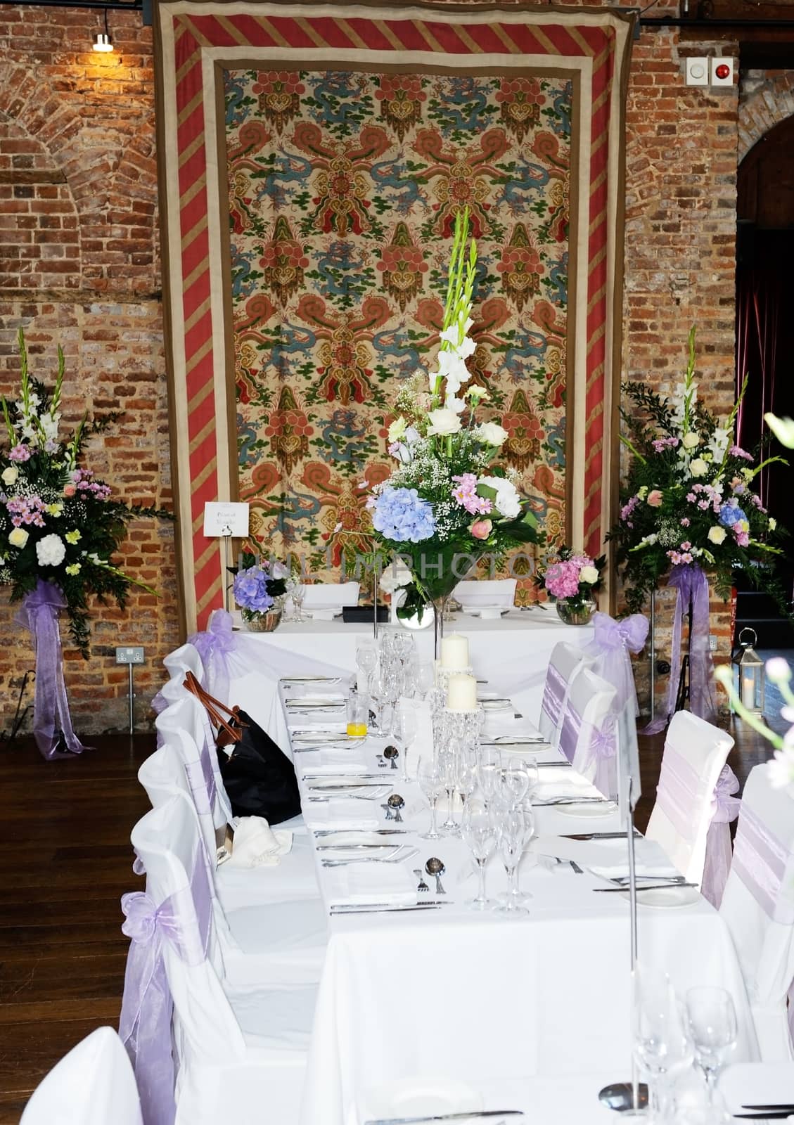 Floral arrangements at wedding reception showing pink, blue and white flowers 