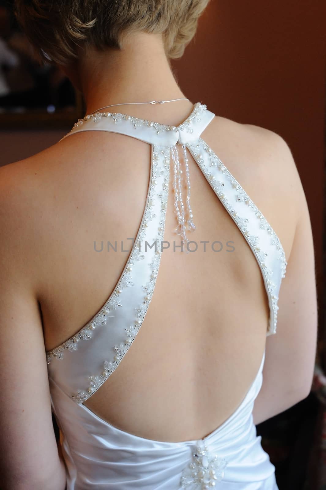 Brides back showing dress detail. by kmwphotography