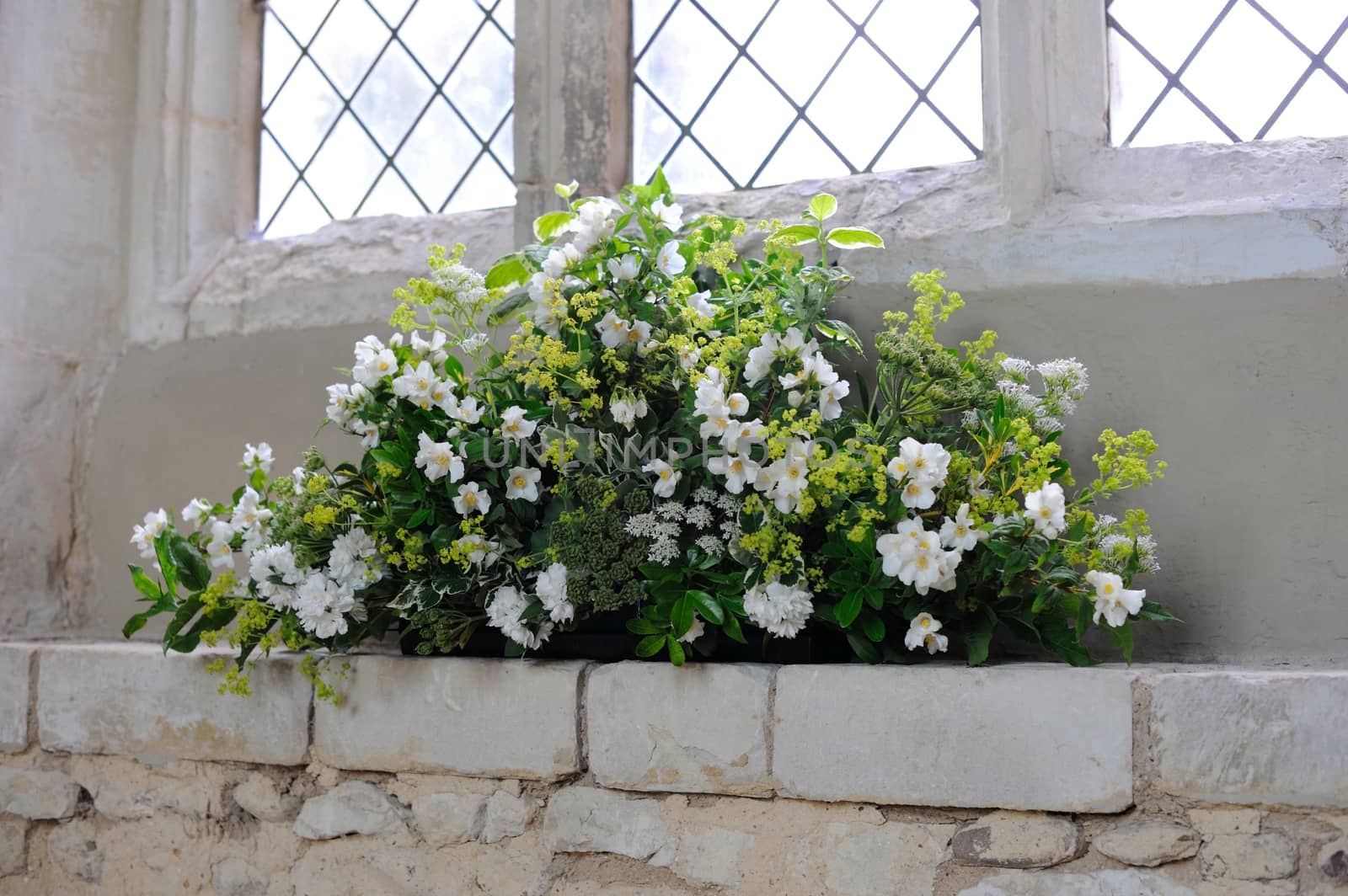 Flowers decorate a church for a wedding.