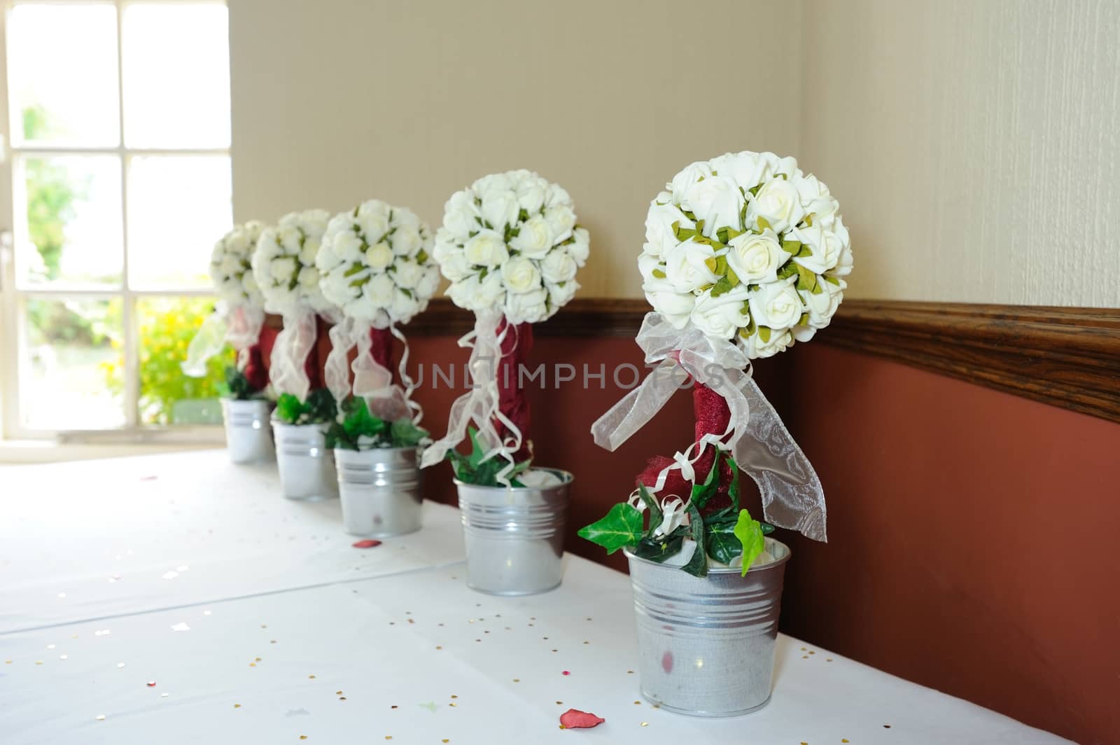 Roses decorate table at wedding by kmwphotography