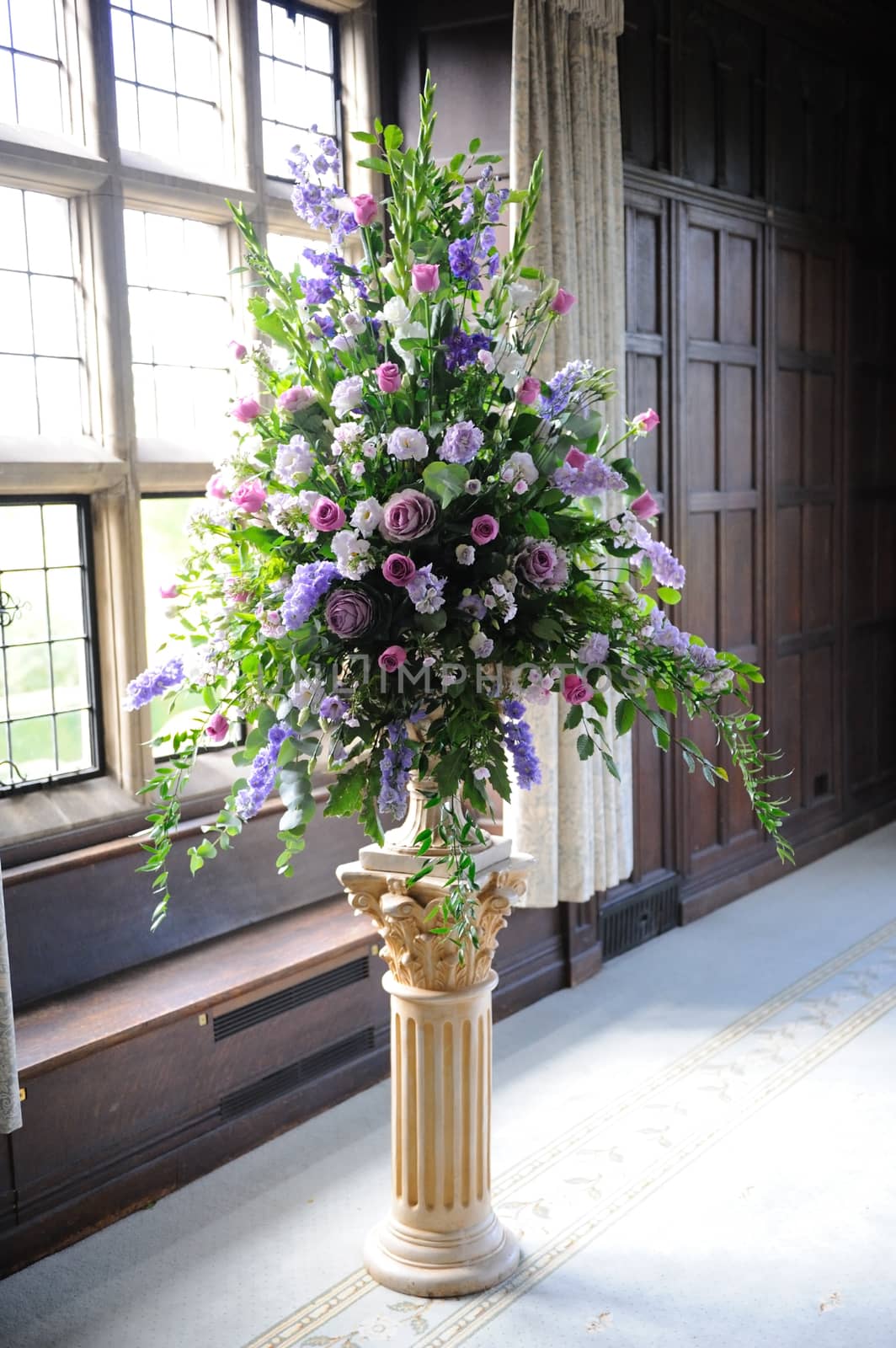 Purple flowers decorate wedding venue.