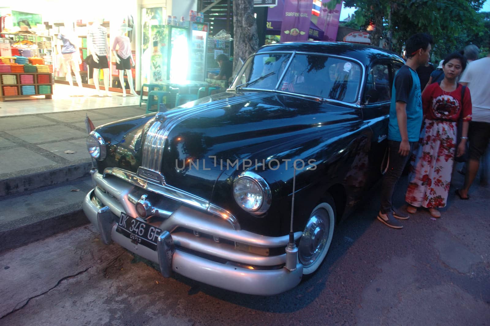 bali, indonesia-november 24, 2012: black colored antique car-hudson hornet on display at tanah lot shopping area beraban, bali-indonesia.