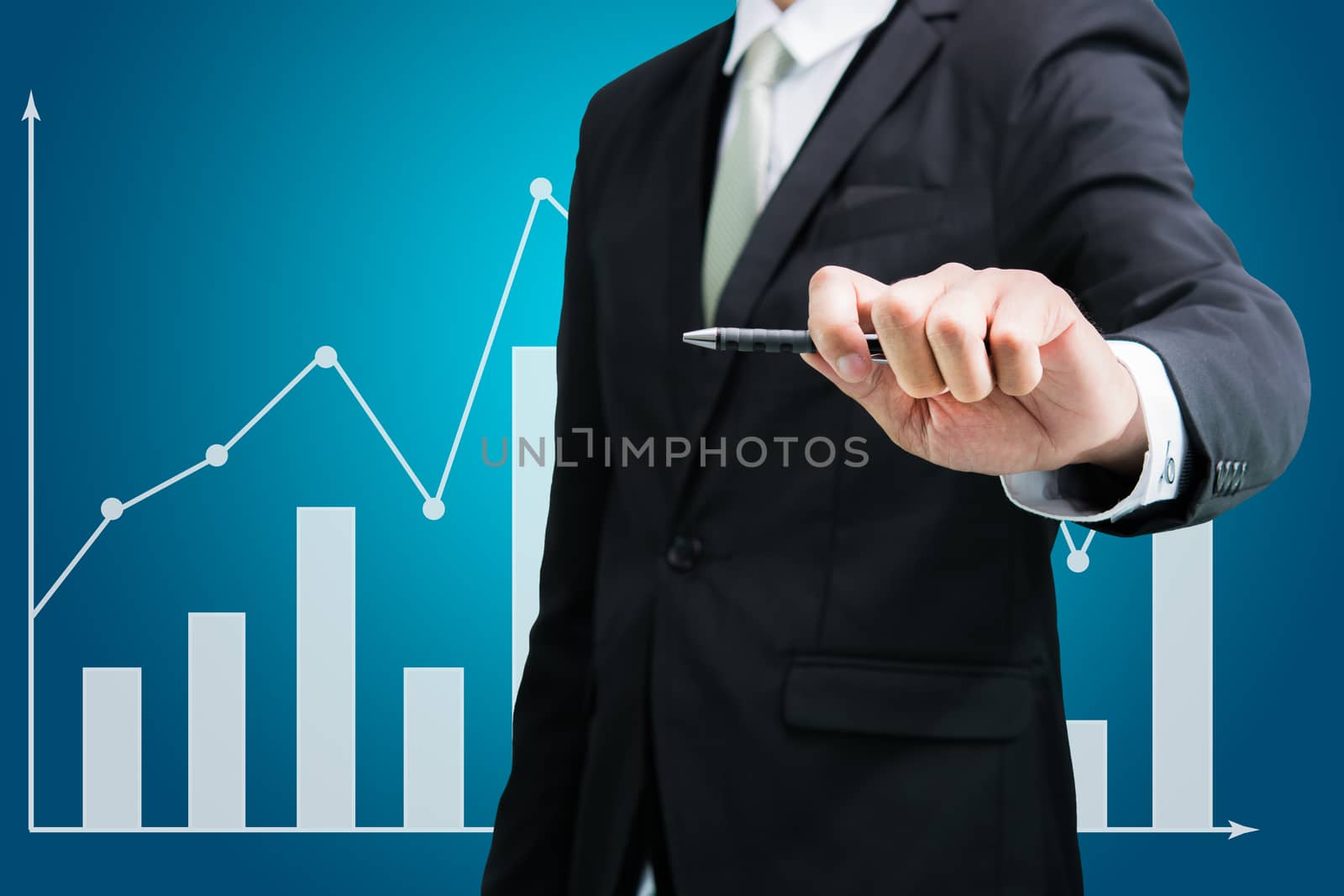 Businessman hand drawing a graph Isolated on blue background