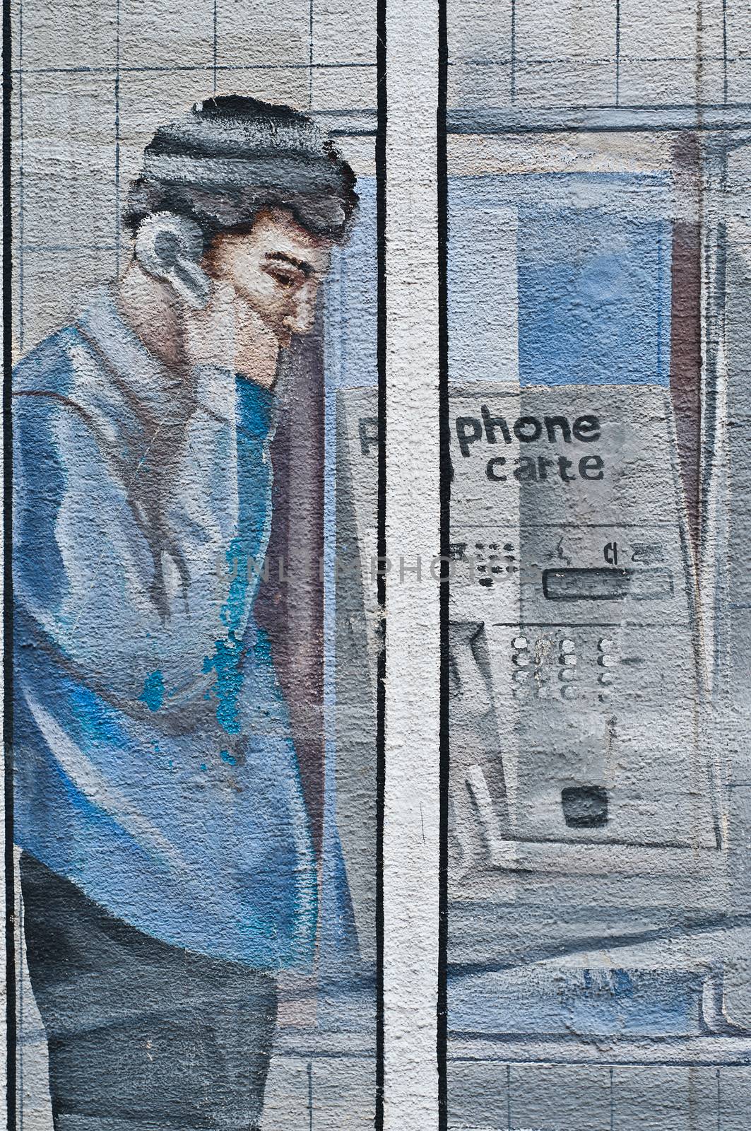 Urban Art - street in Mulhouse - man in a phone cab by NeydtStock