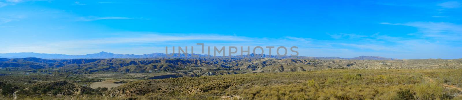 Panoramic mountain landscape view with blue sky