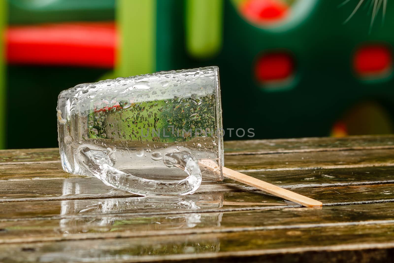 Empty wet glass outside on table  by frankhoekzema
