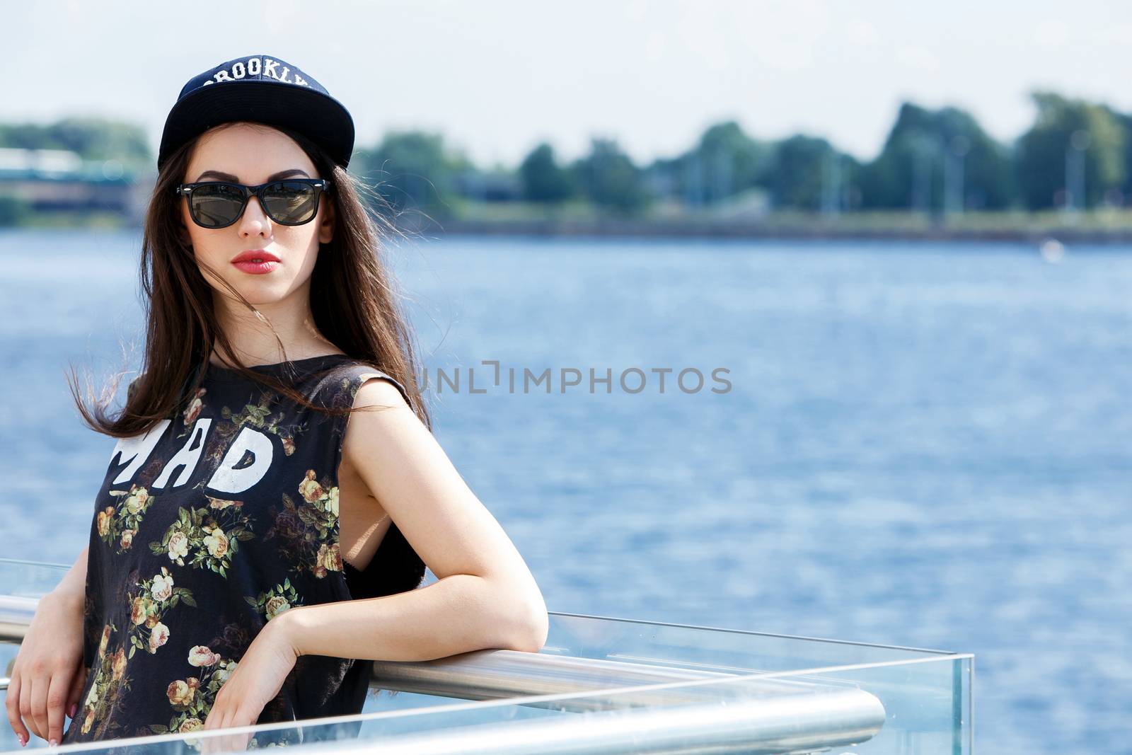 Street, outdoor. Attractive teen in a cap