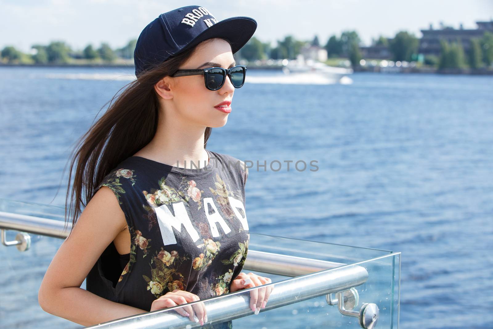 Street, outdoor. Attractive teen in a cap