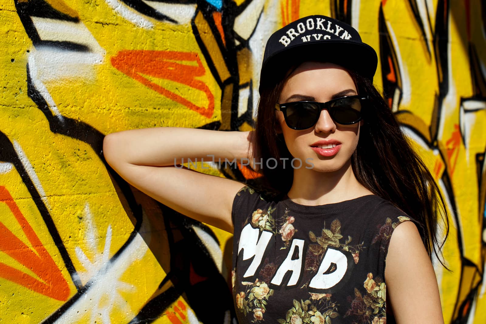 Street, outdoor. Attractive teen in a cap