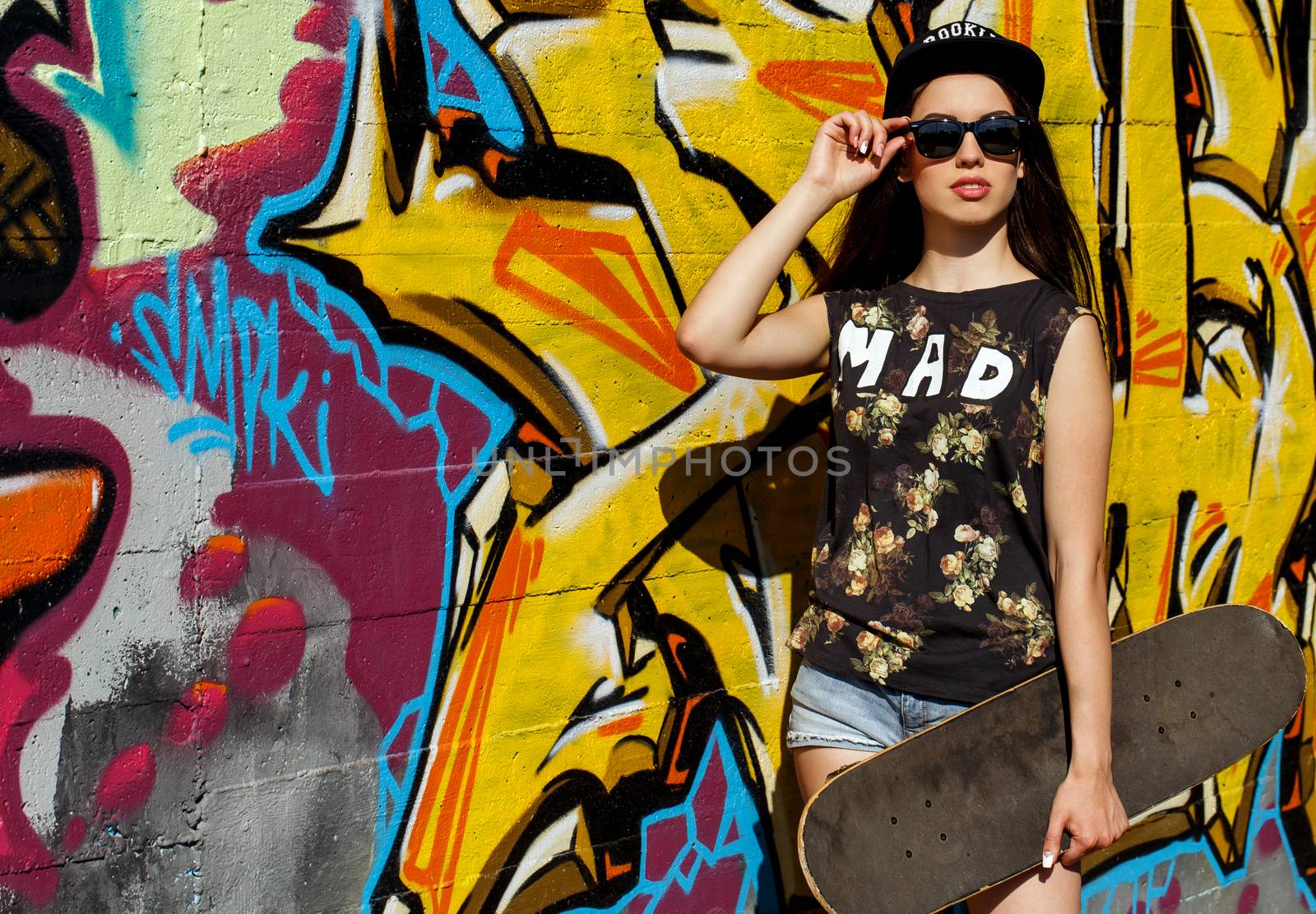 Street, outdoor. Attractive teen in a cap