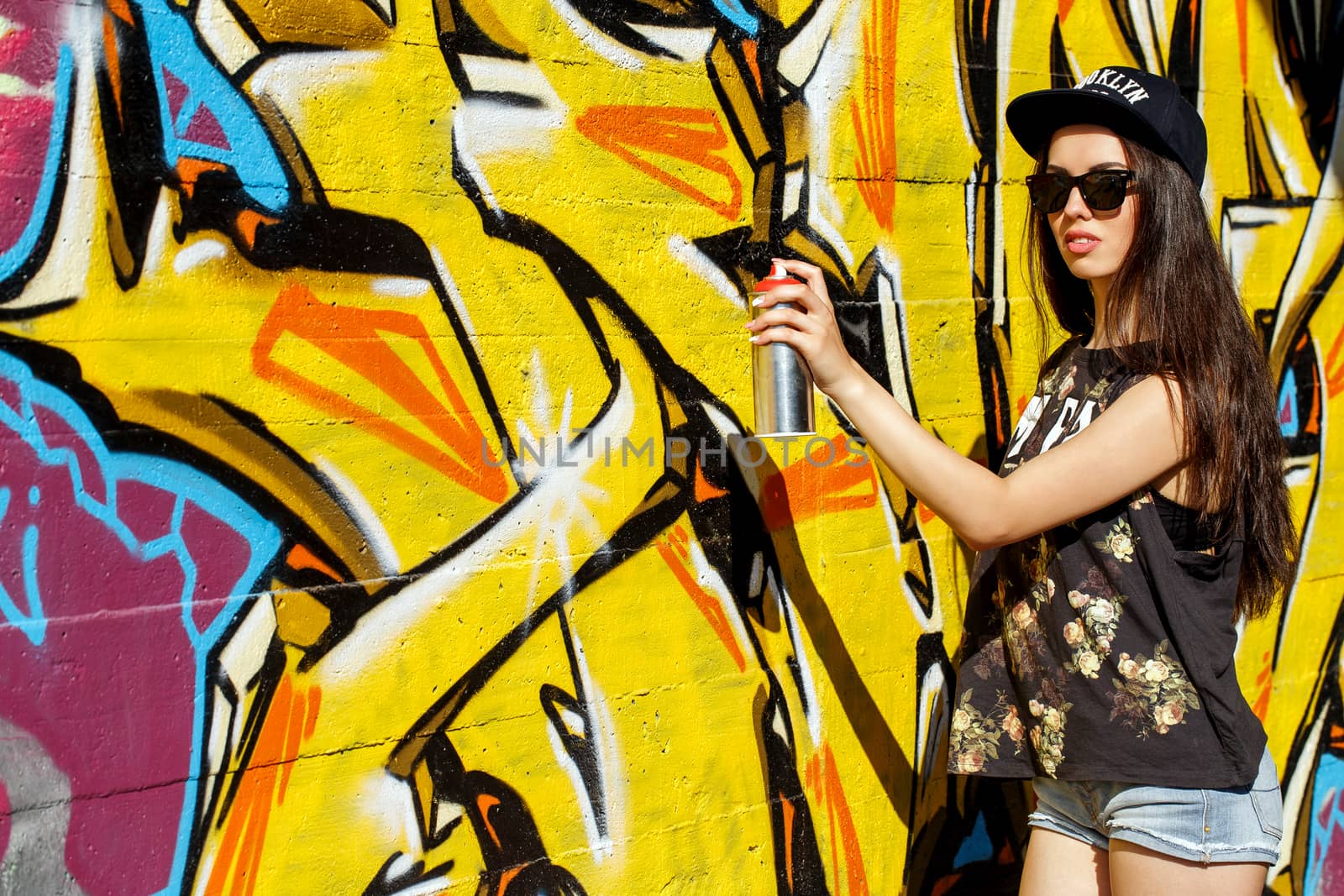 Street, outdoor. Attractive teen in a cap