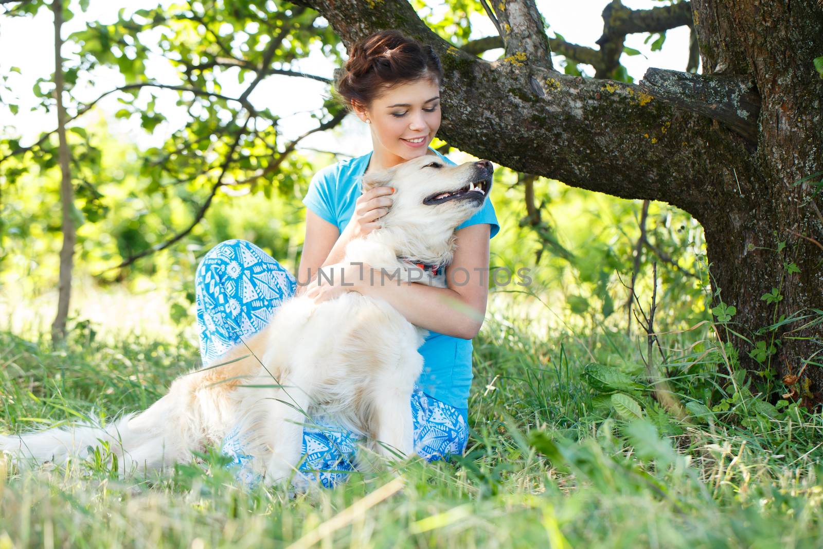 Cute girl in blue dress with adorable dog