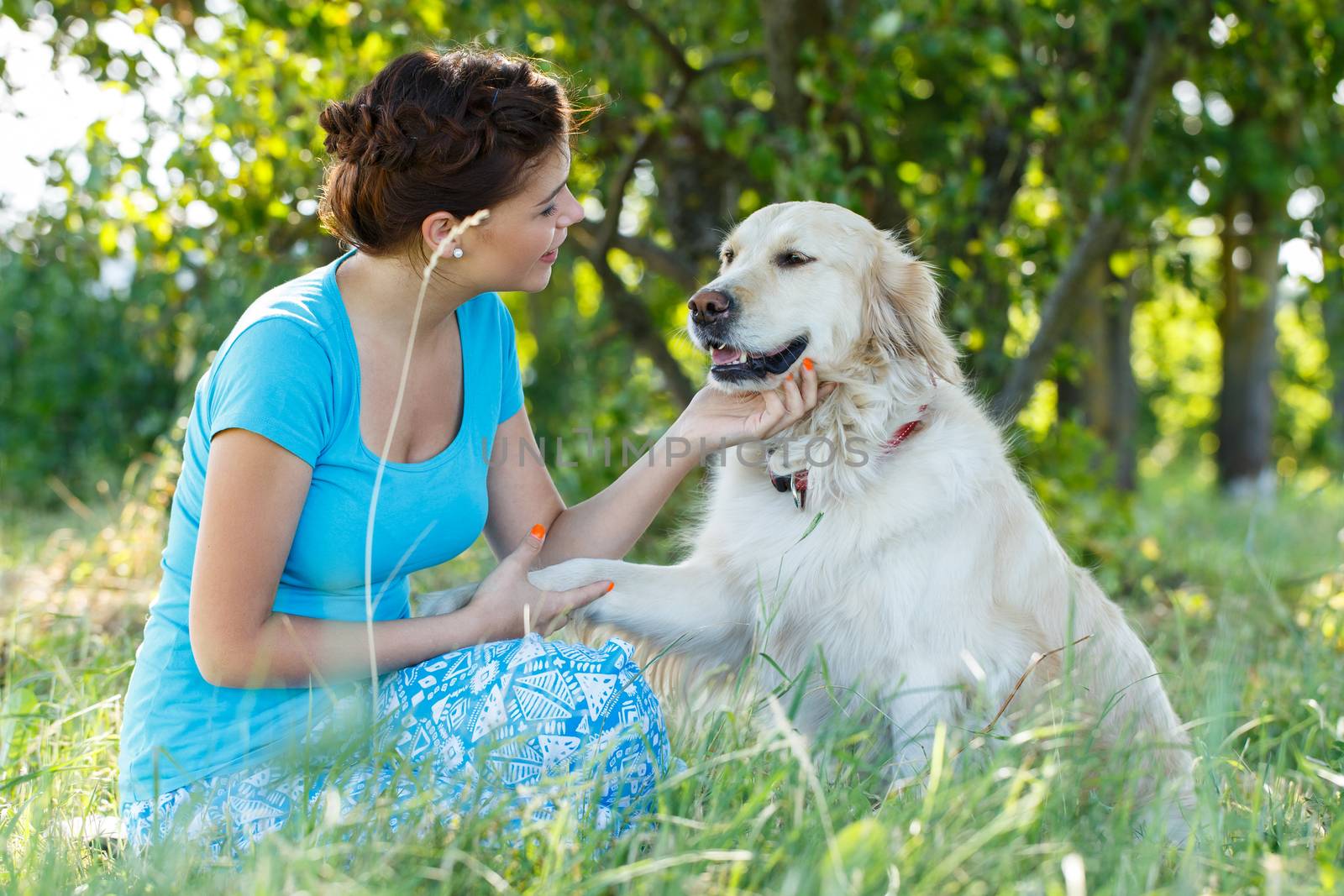 Cute girl in blue dress with adorable dog