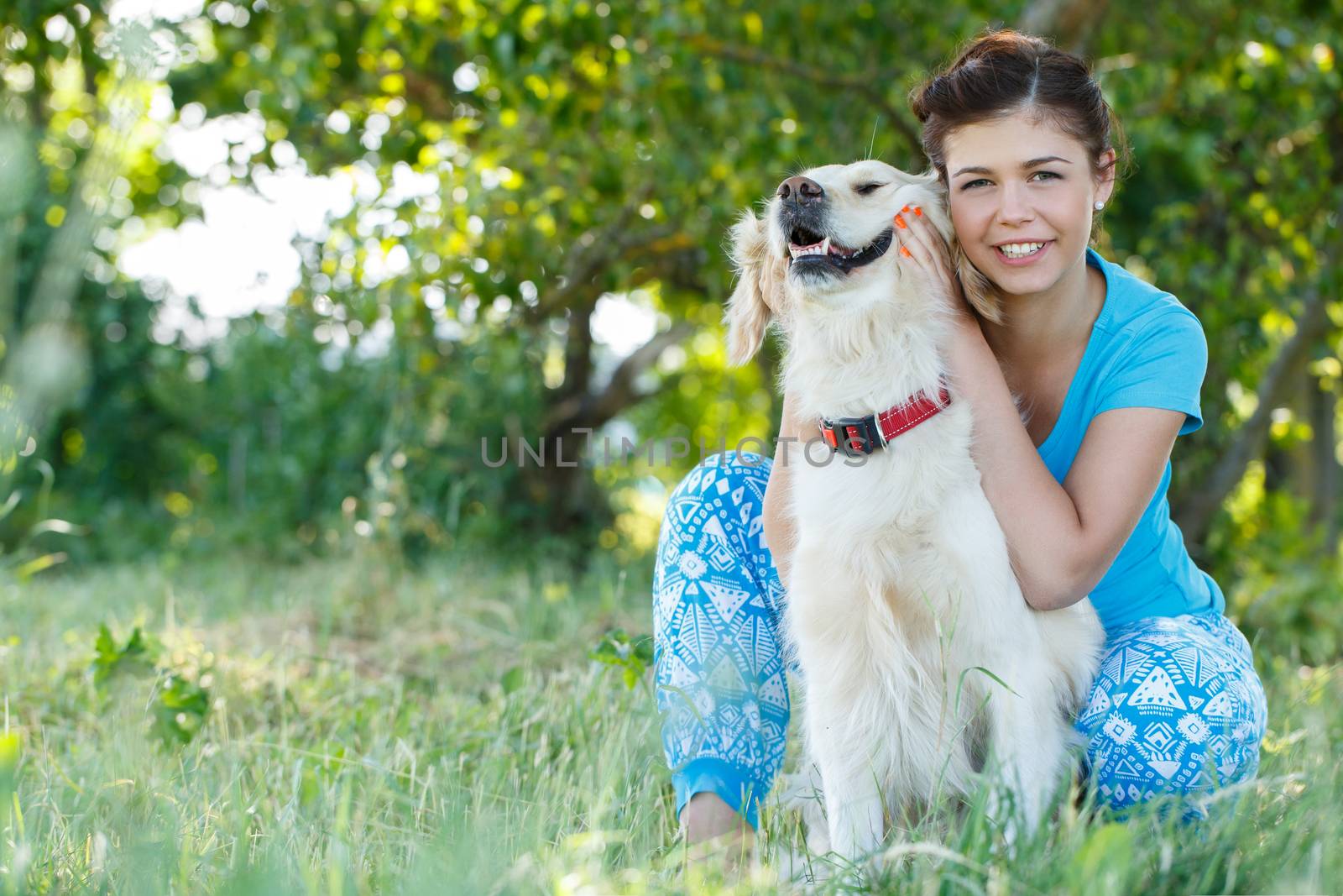 Cute girl in blue dress with adorable dog