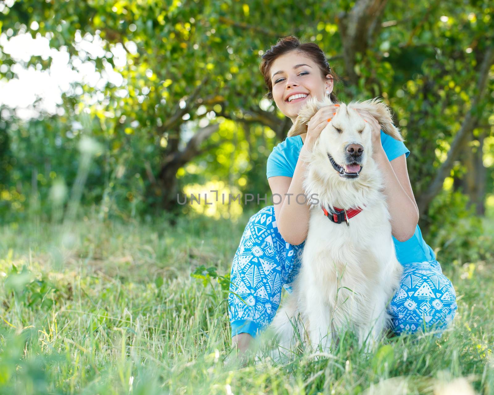 Cute girl in blue dress with adorable dog