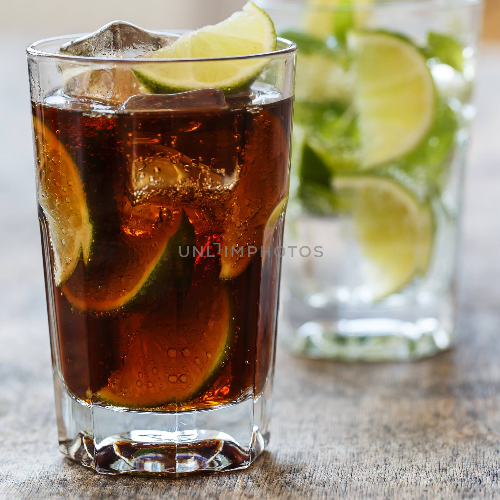 Cold, fresh. Delicious drink with lime on the table