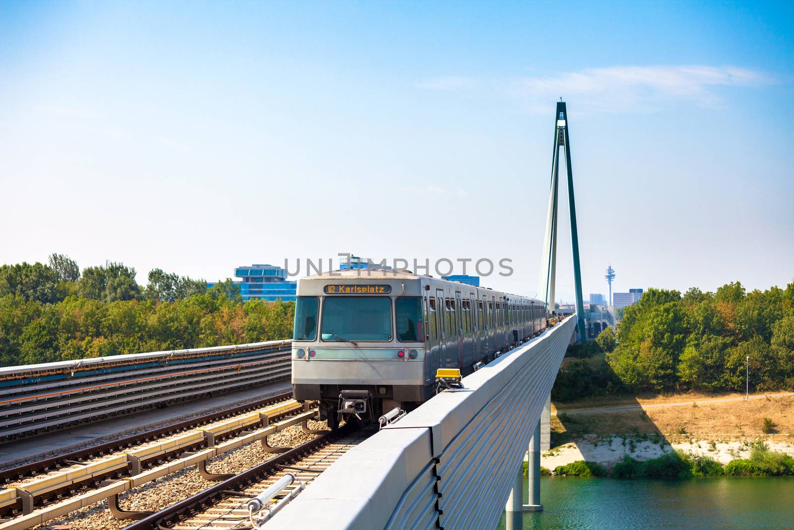 VIENNA, AUSTRIA - AUGUST 6: Vienna metro train passing a bridge over Danube river, Austria