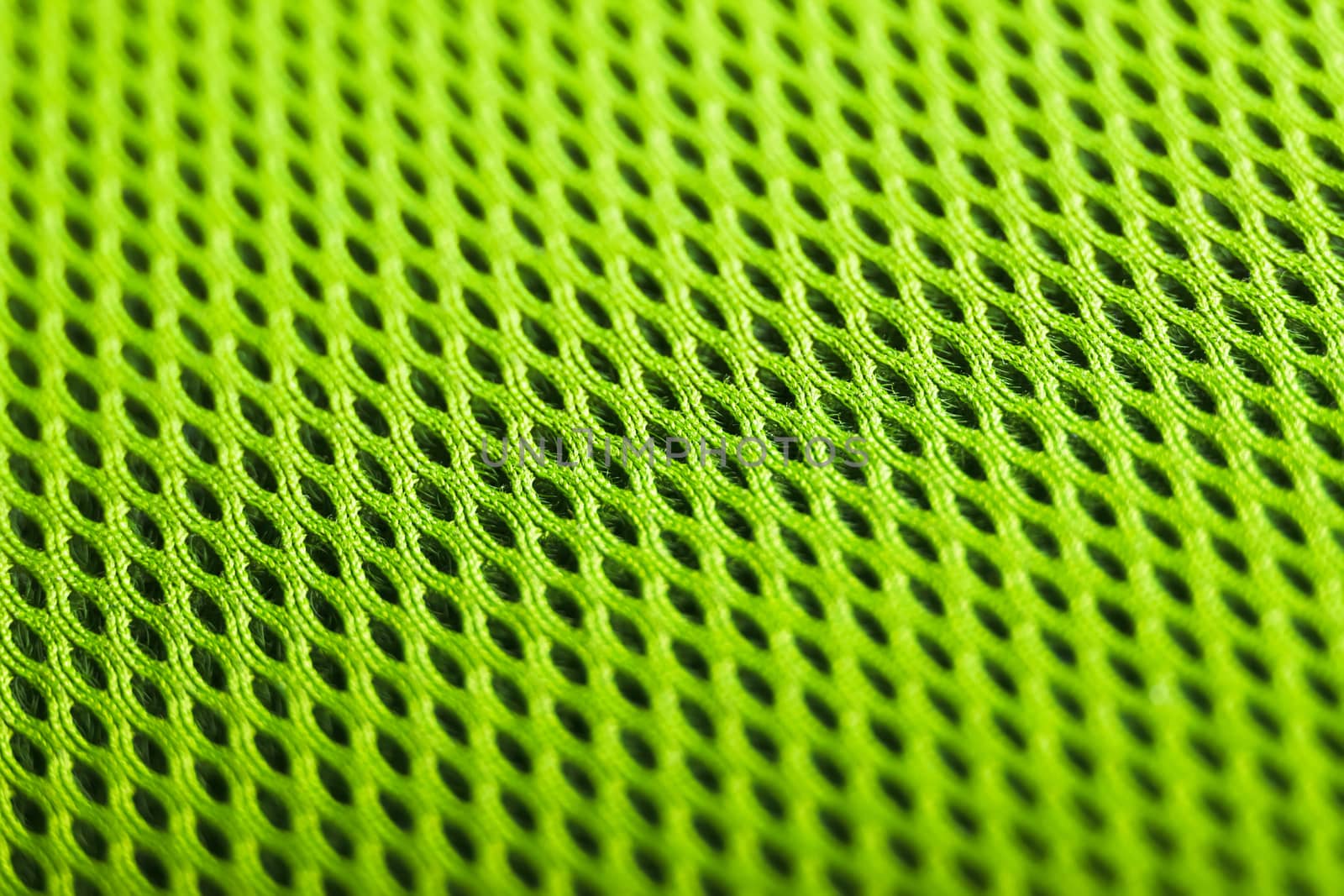 green background. Mesh fabric texture. Macro perspective