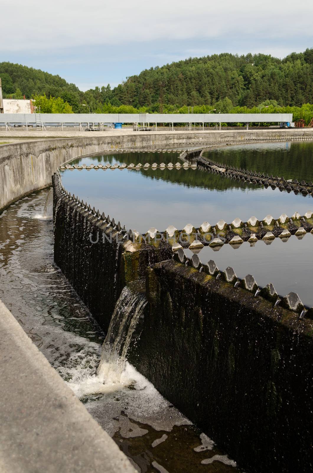 Reservoir of cleaned sewage water clarification step in treatment waterworks. Birds swim.