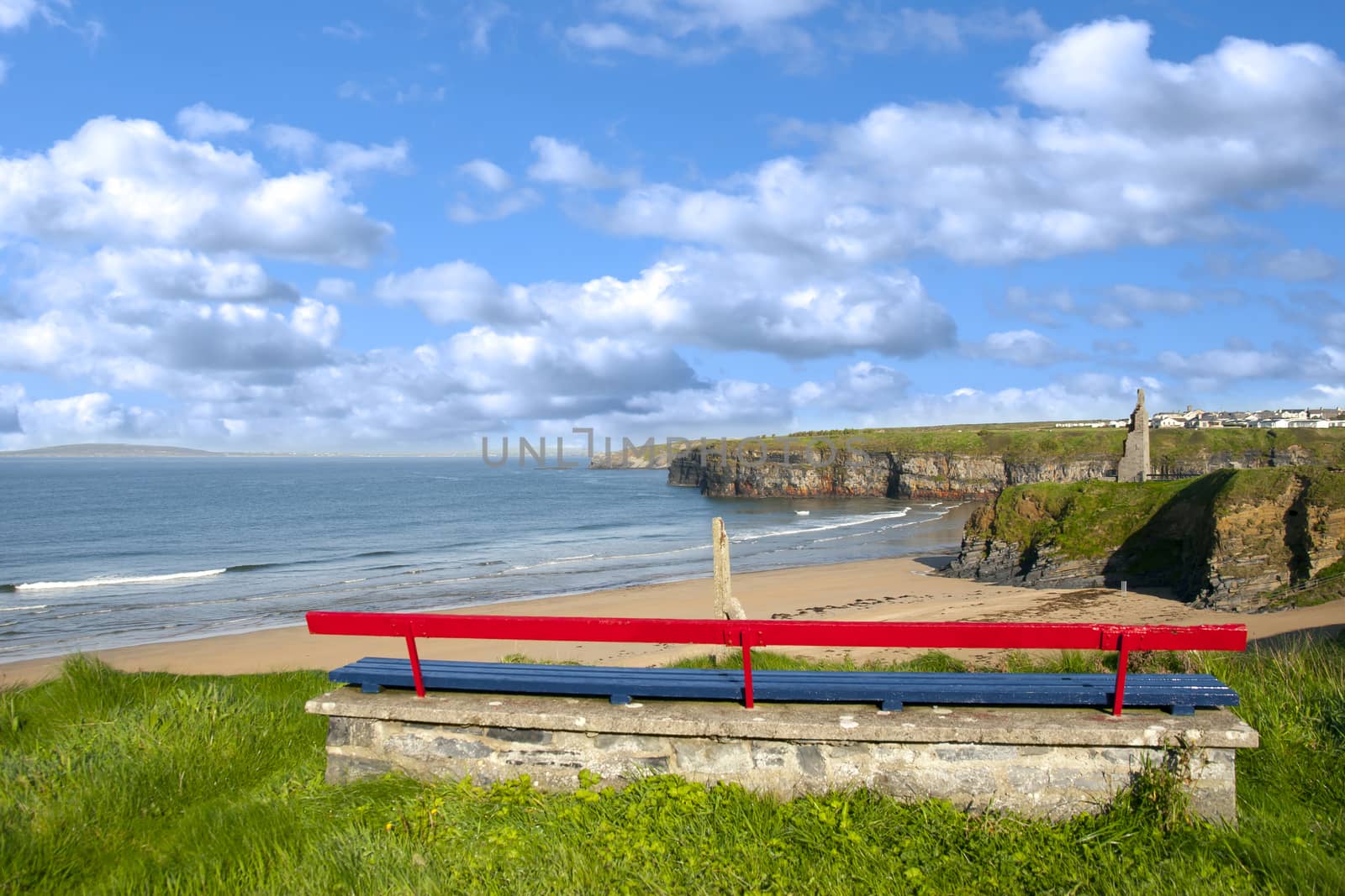 bench on a cliff edge with views of Ballybunion beach cliffs and castle