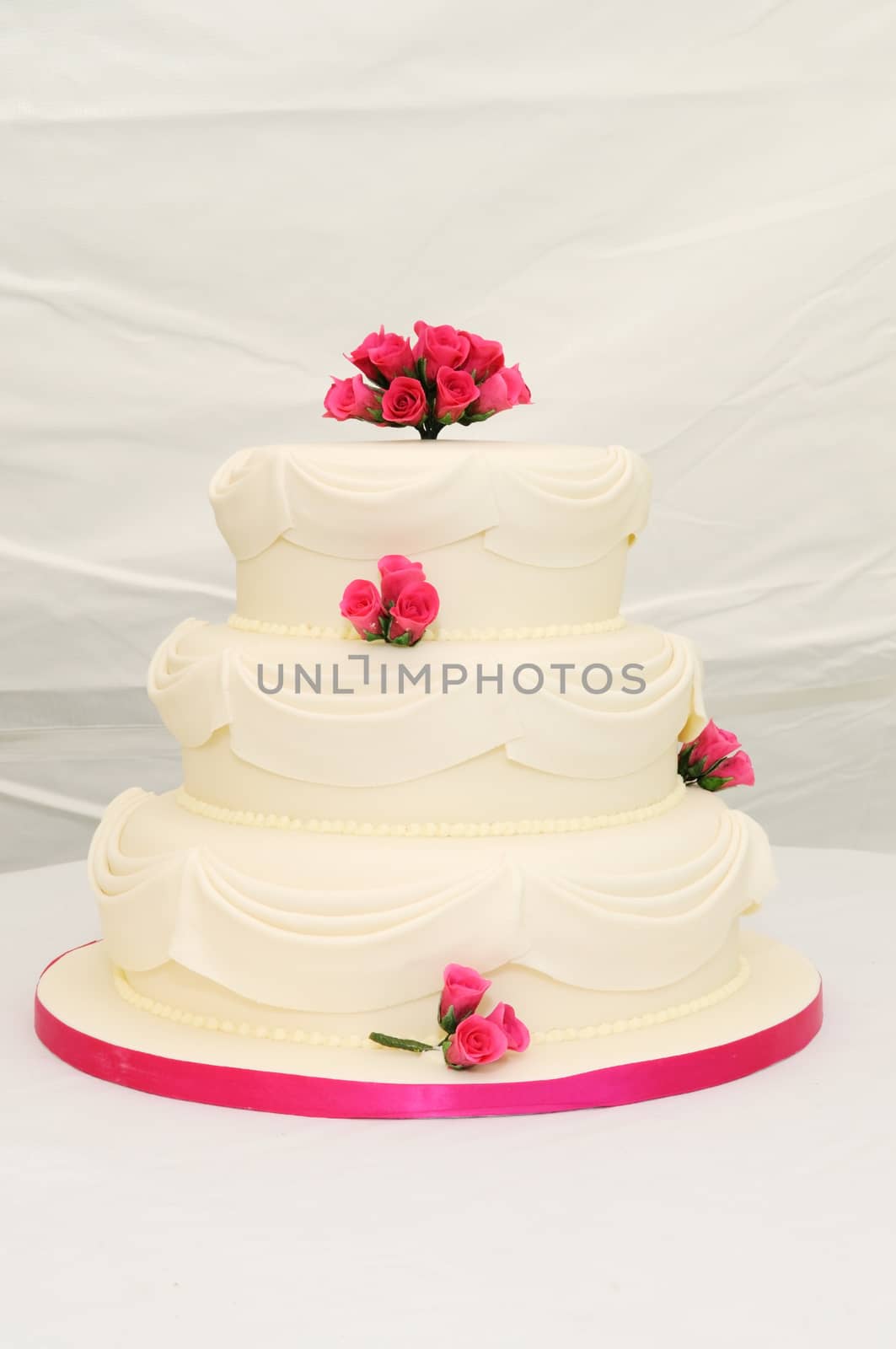 Wedding cake with pink decoration. by kmwphotography