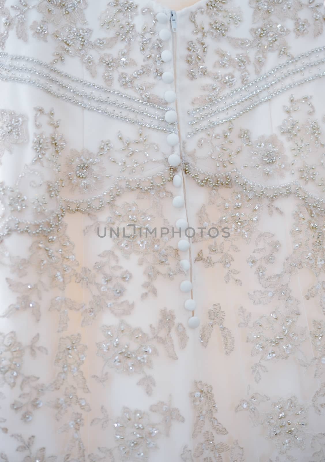 Close-up of brides dress detail on wedding day