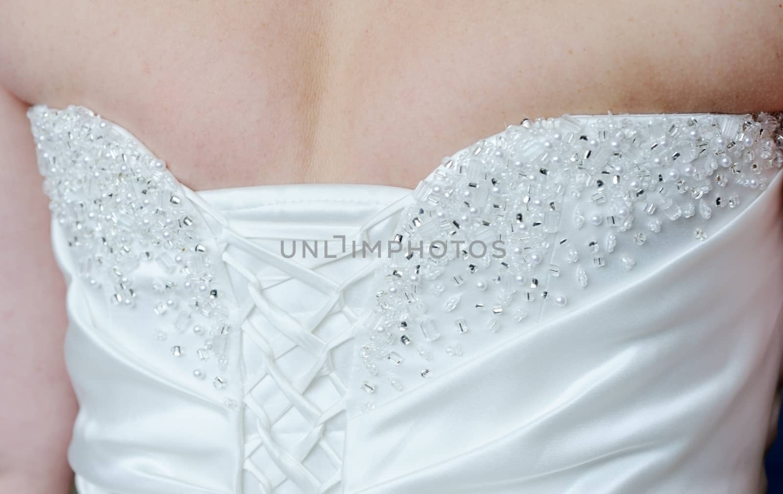 Closeup of brides dress back showing detail on wedding day