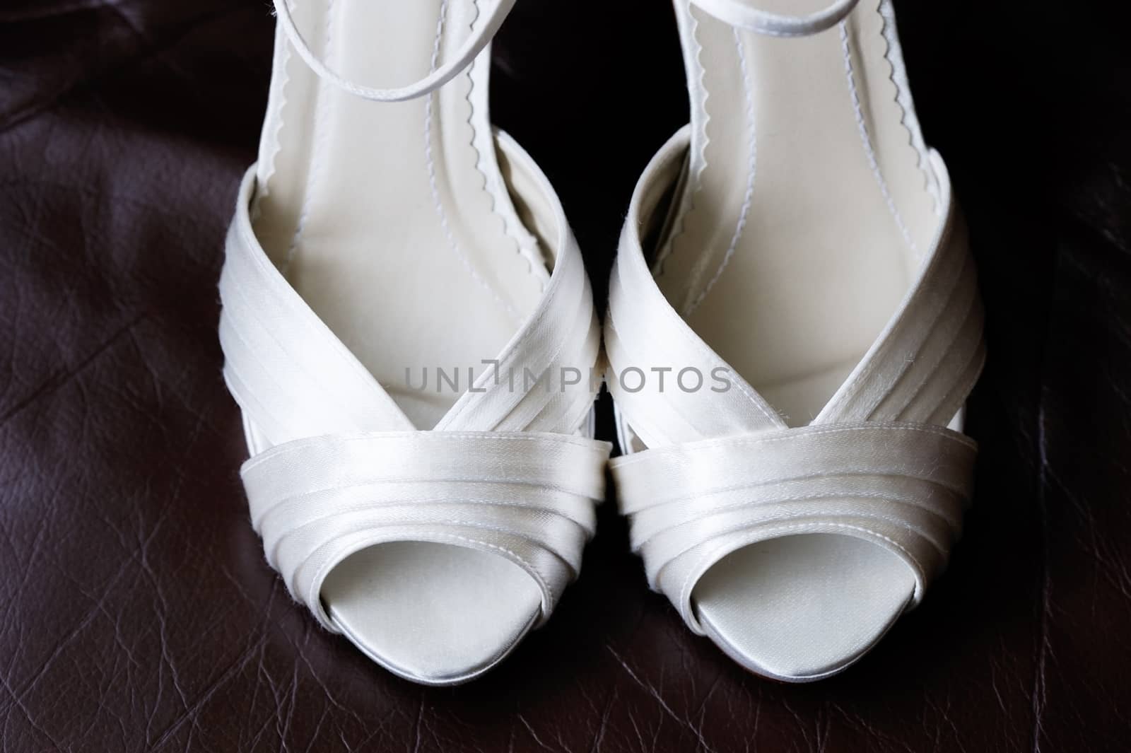 Close of brides shoes showing detail on wedding day