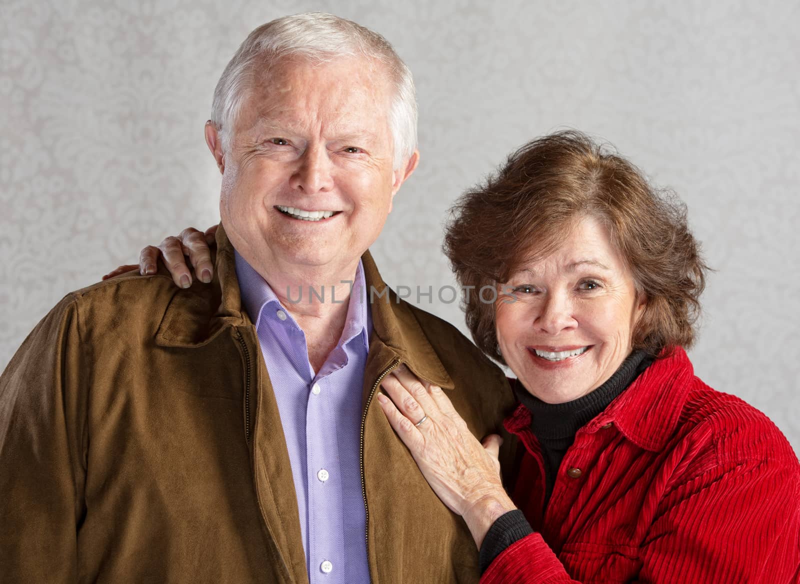 Happy smiling white senior couple standing together