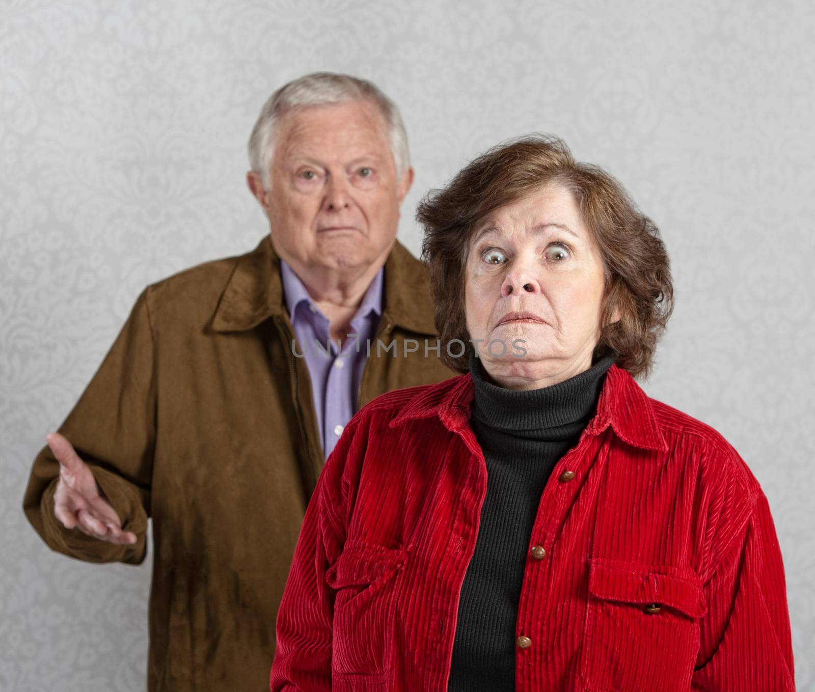 Stiff older woman in front of confused man