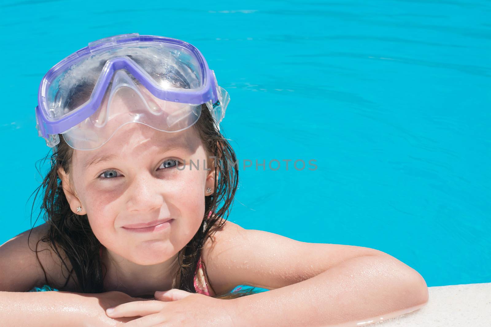 young happy girl in the pool with lots of copy space and room for text