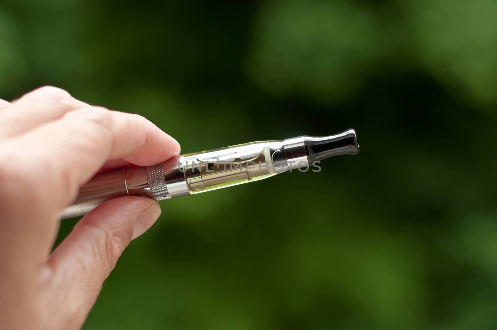 e-cigarette with hand closeup in outdoor